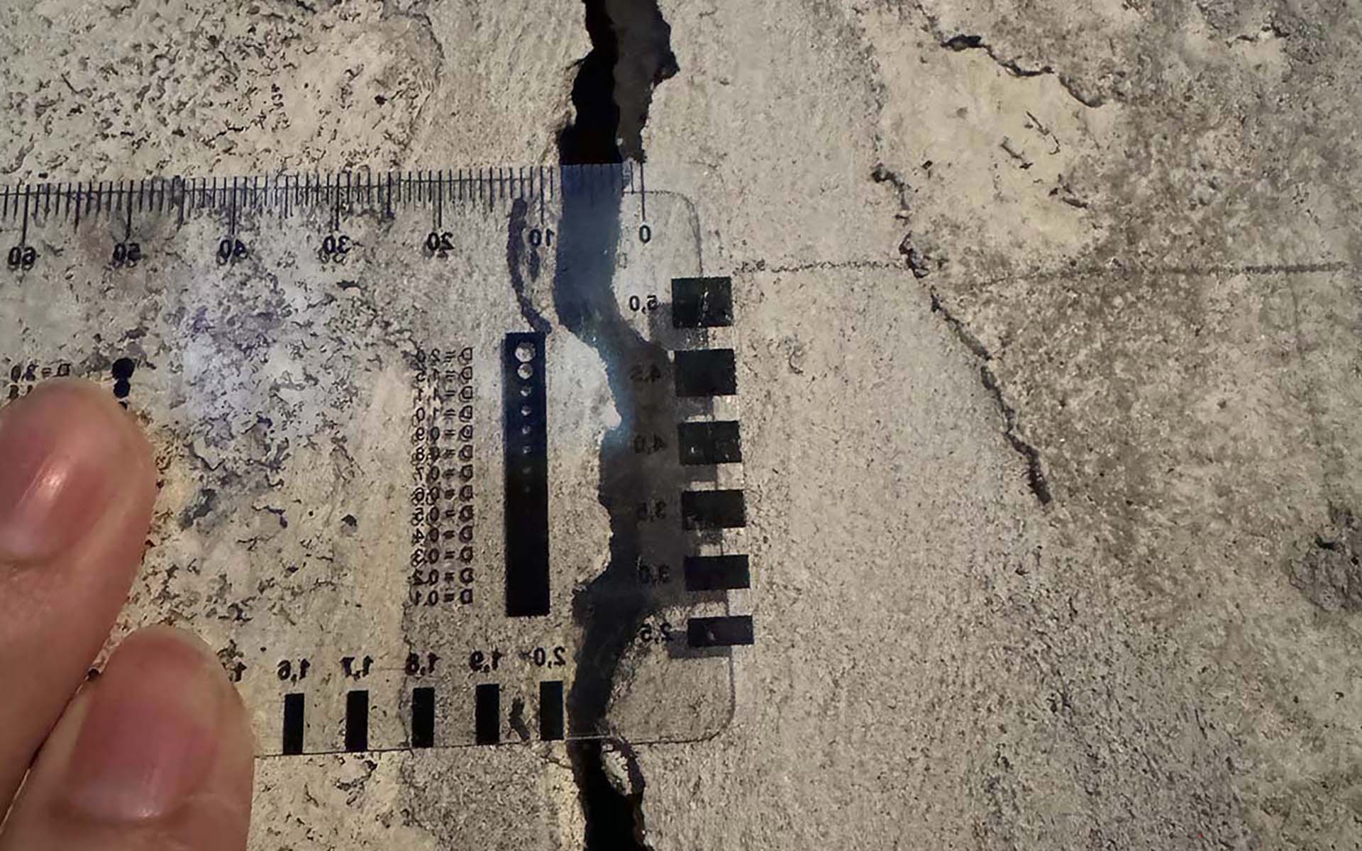 Measured concrete crack with scale for forensic documentation
