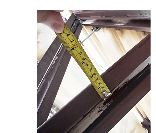 Structural inspection measuring steel framing during forensic assessment