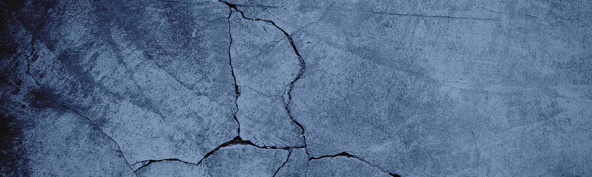 Cracked concrete surface showing multi-directional structural distress