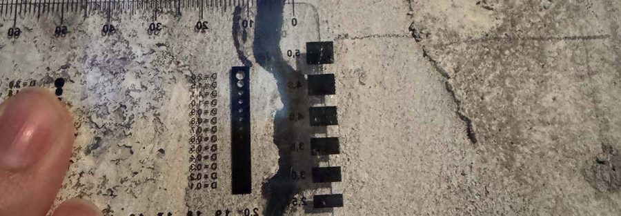 Measured concrete crack with scale for forensic documentation