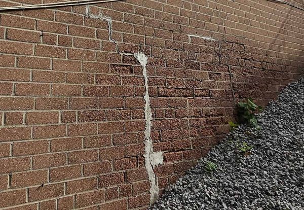 Building-Envelope-Structural-Performance-Loadcase Forensic engineering photo of stair-step cracking in a masonry wall caused by building envelope failure and structural settlement.